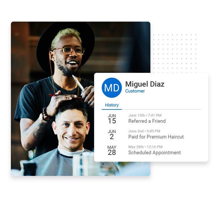 Smiling barber with client overlaid with client history details from the Marketing 360® CRM salon CRM